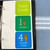 Set of 7 colorful whiteboard clings showing hand signals for classroom voice levels 0 to 4 with a movable black arrow indicator.