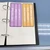 Pastel CHAMPS help and activity option clings stored in a three-ring binder