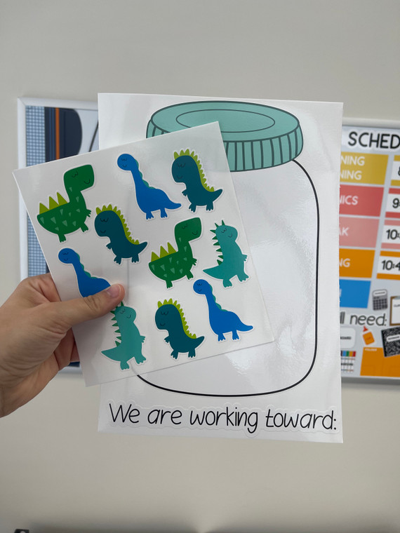 Dinosaur clings held over the incentive jar to show the reusable static cling