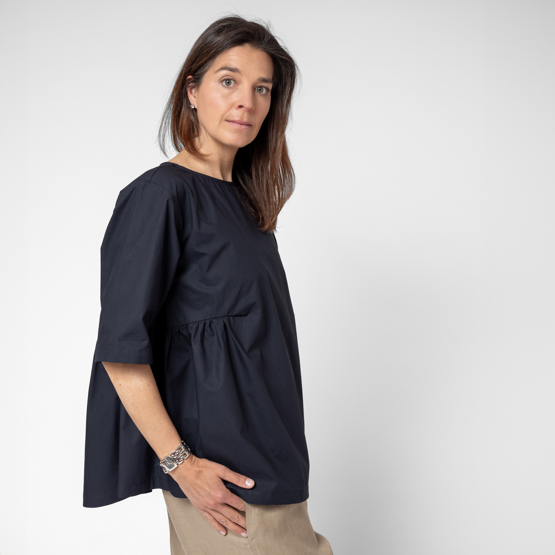 Photo of model wearing our Felice side-gathered top. Light and loose-fitting, it's made in Australia from premium quality, cool crisp cotton poplin.