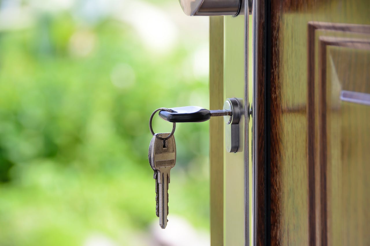 black handled key on key hole of a front door