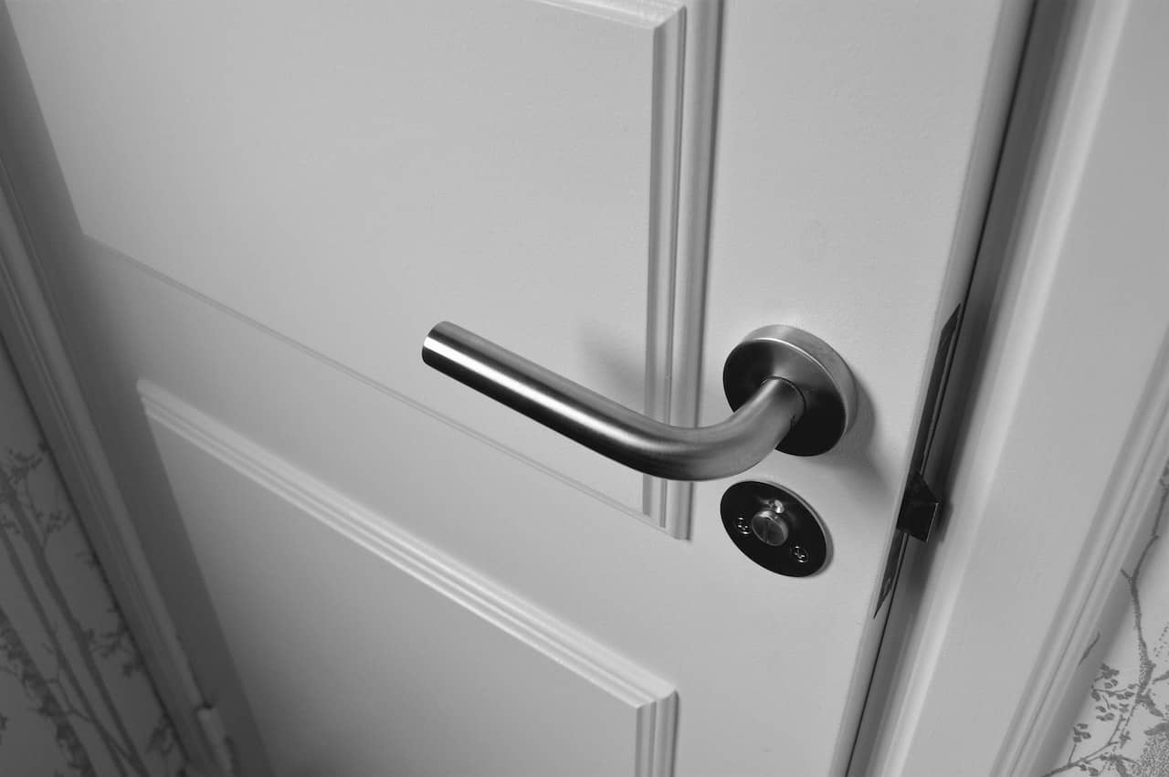 white door with lock and lever