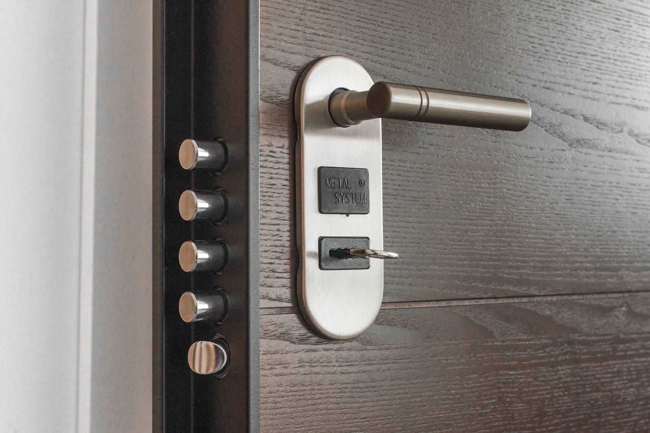 a smart lock on a door with a key sticking out of it
