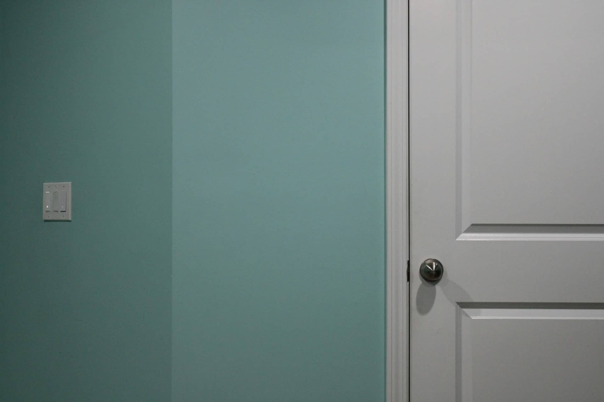 teal room with silver door knob