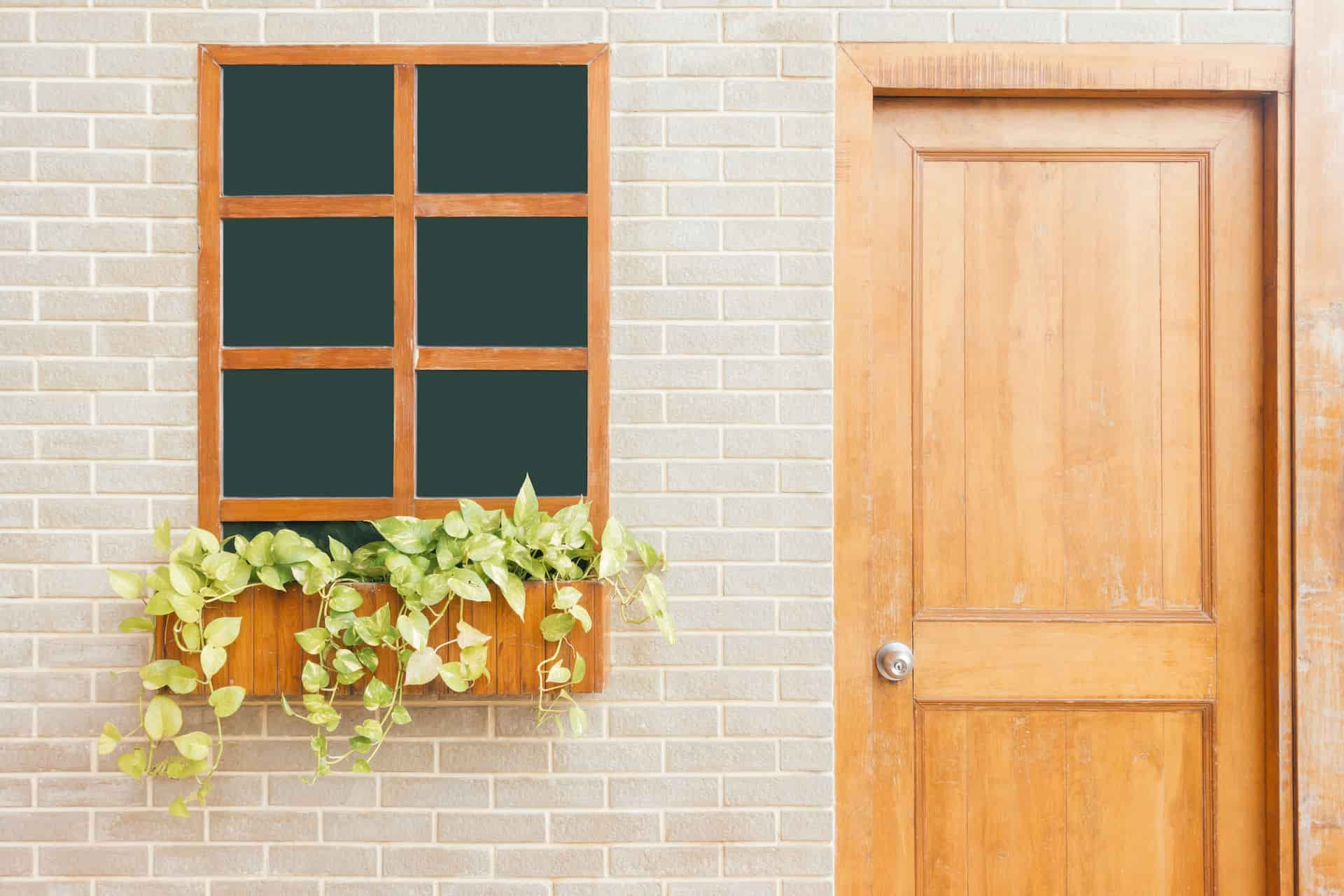 wooden door near window with keyed entry door knob