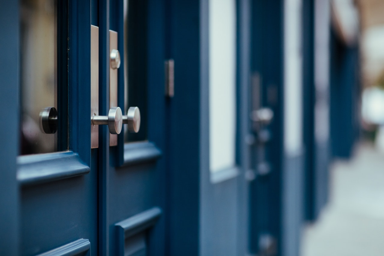 blue wooden French doors with commercial door hardware