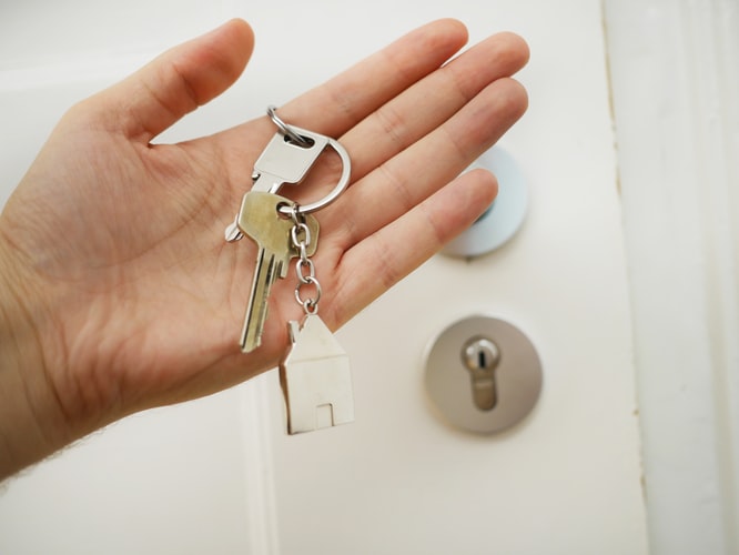 Someone holding a set of house keys in their hand