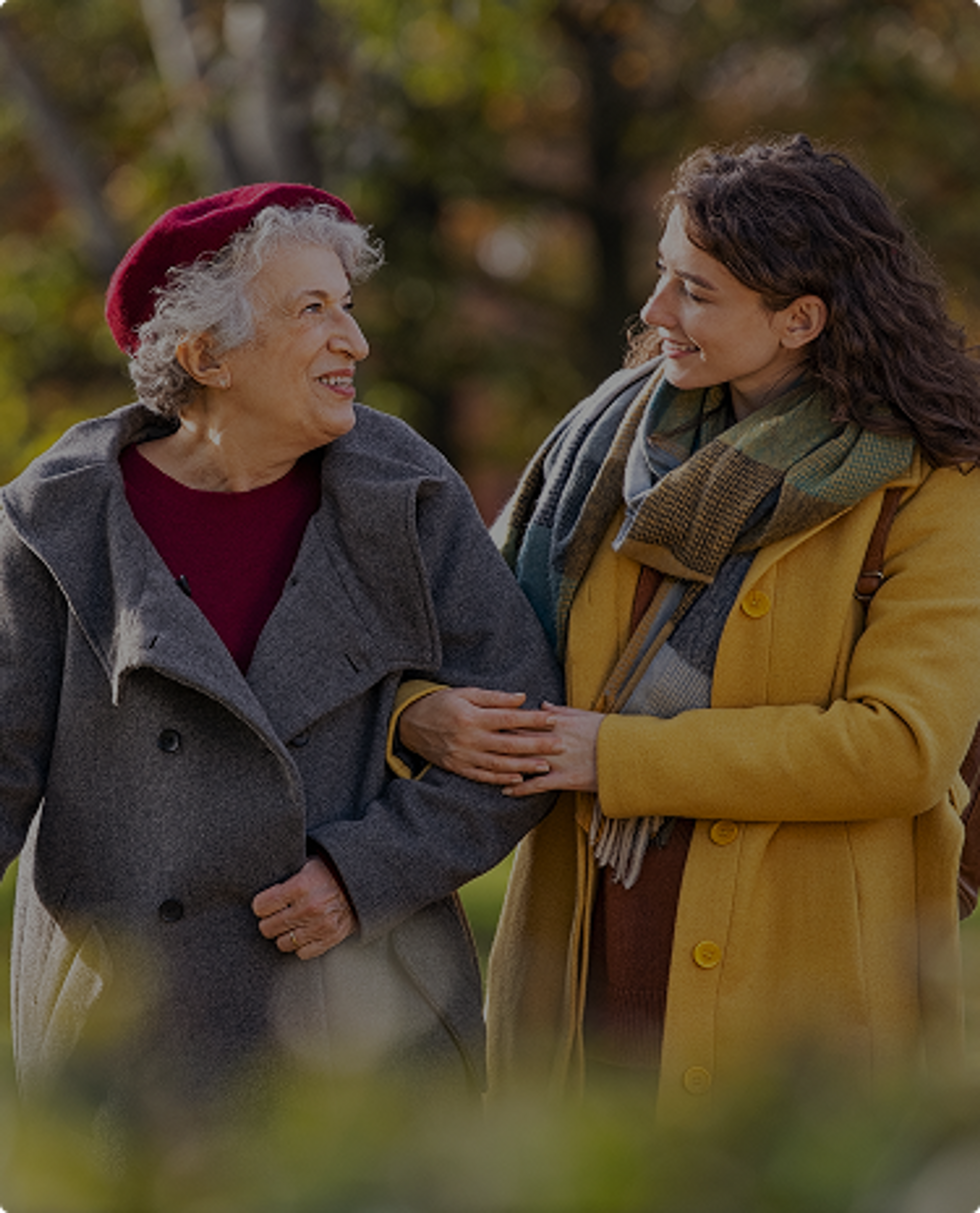 Two women walking through a park