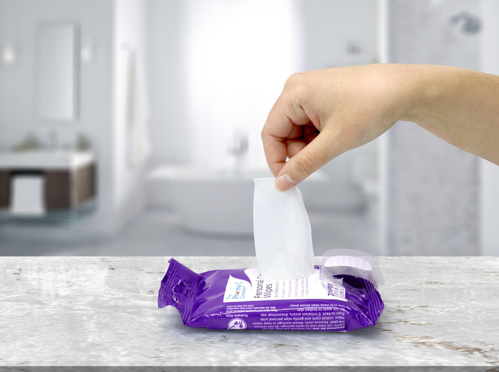 Personal Cleansing Wipes hand pulling wipes out of package