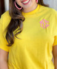 Monogrammed yellow tee close up