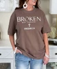 broken but chosen tee brown close up