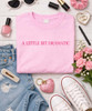 A little bit dramatic pink graphic tee flat lay