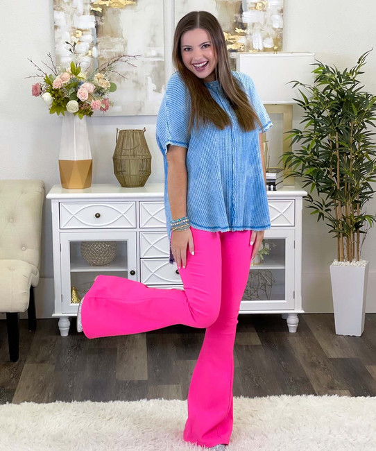 High-waisted pink jeans with visible buttons