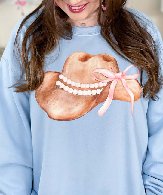 cowirl hat with bow and pearls sweatshirt close up