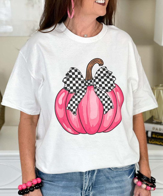 pink pumpkin with black and white checkered bow tee close up