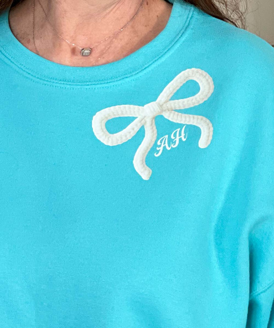 monogrammed pocket faux yarn bow sweatshirt close up of monogram