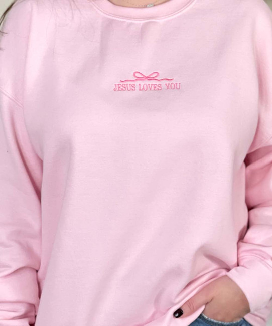 Embroidered jesus loves you with bow sweatshirt close up
