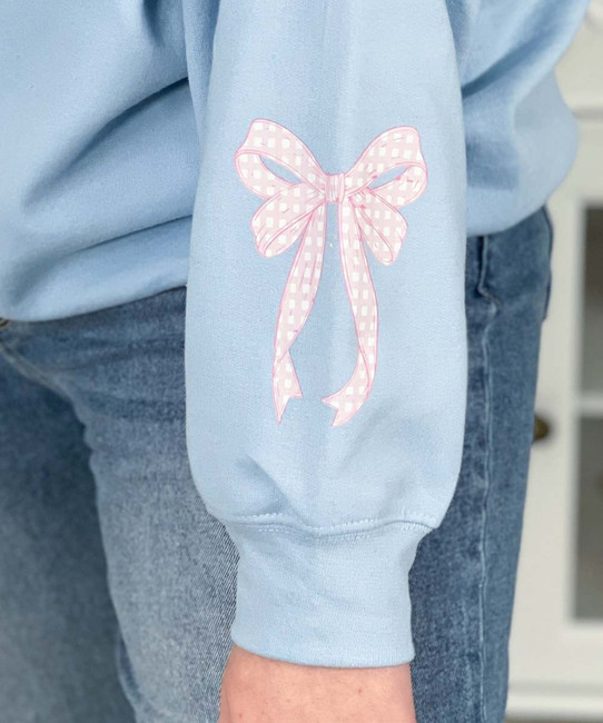 light pink gingham mama with bow on sleeve sweatshirt close up of sleeve