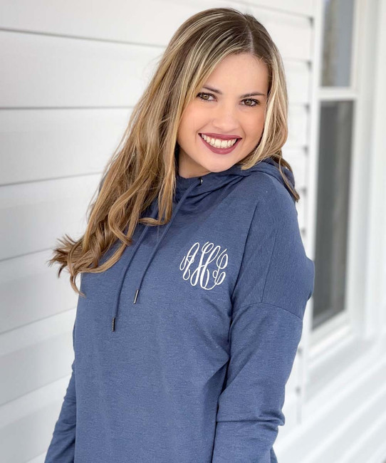 A young woman wearing a monogrammed hoodie