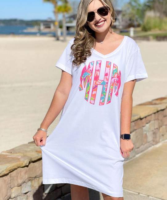 A young woman wearing a monogrammed cover-up