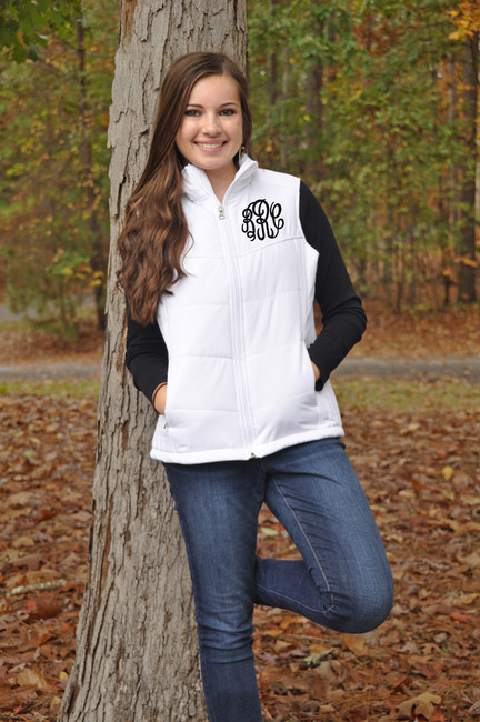 A young woman wearing a monogrammed vest