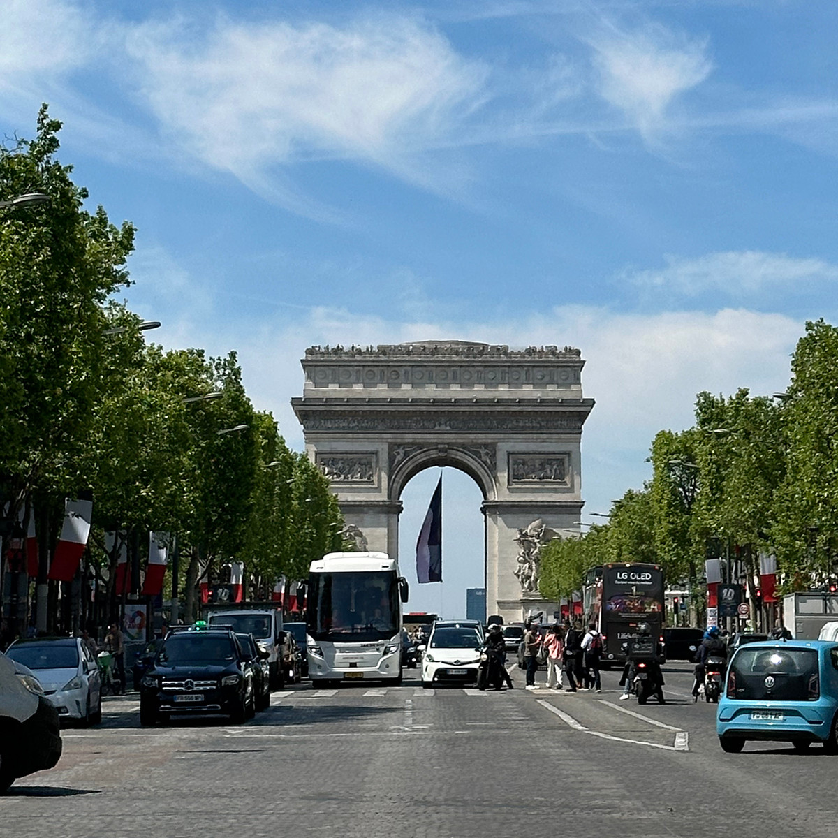 The Champs-Élysées unfolds toward the Arc de Triomphe, one of Paris’ most iconic urban perspectives. Lined with trees, cafés, luxury boutiques and constant city movement, this grand avenue remains a symbol of Parisian life, celebration and elegance.