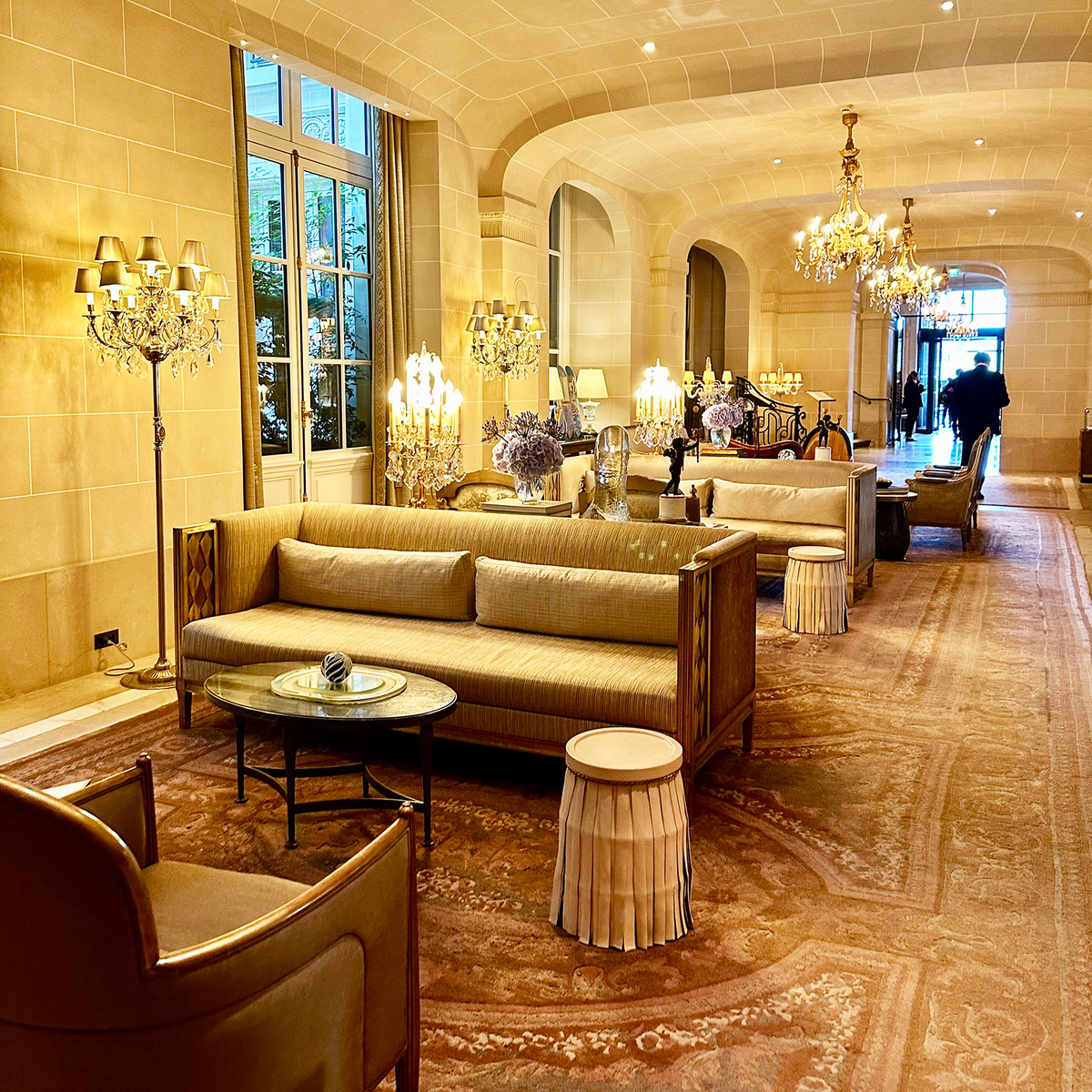 A luminous lounge space where soft light, chandeliers, and refined textures create a timeless palace atmosphere.