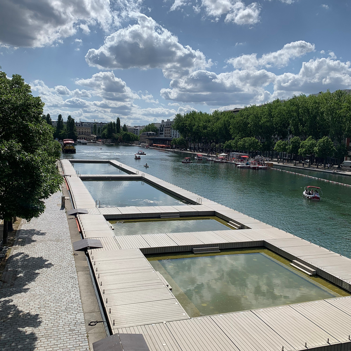 During the summer months, the Bassin de la Villette transforms into one of Paris's most popular outdoor leisure areas, with supervised swimming pools, floating pontoons, pedal boats and waterfront cafés. It is one of the city's favourite places to cool off while enjoying the lively atmosphere along the Canal de l'Ourcq.