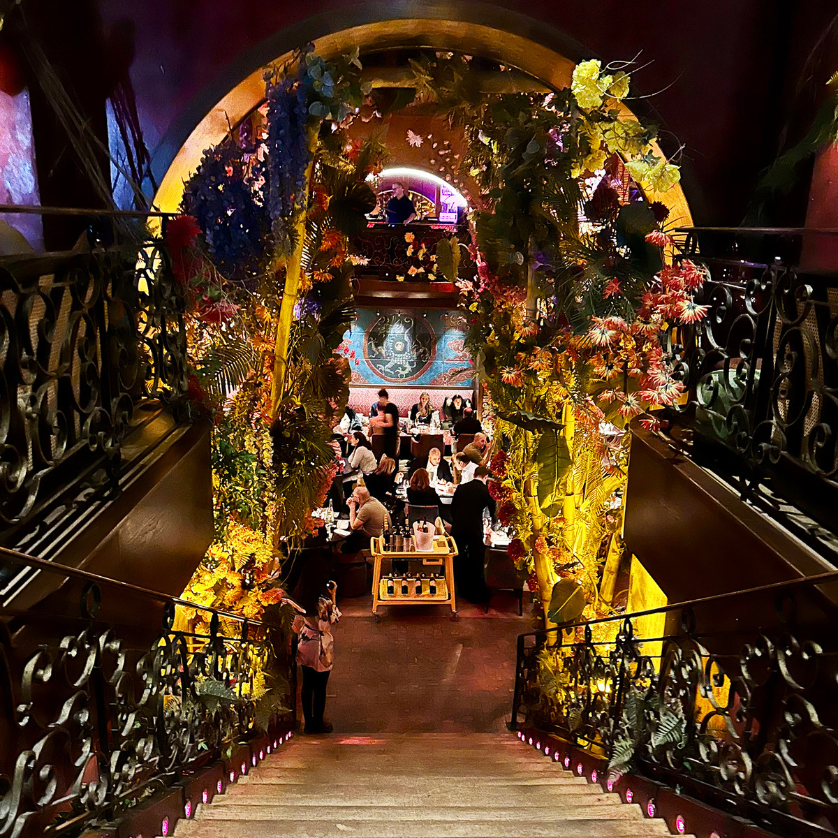 A dramatic staircase leads into Buddha-Bar Paris, where Asian-inspired décor, music, and candlelit dining create one of the city's most distinctive restaurant experiences.