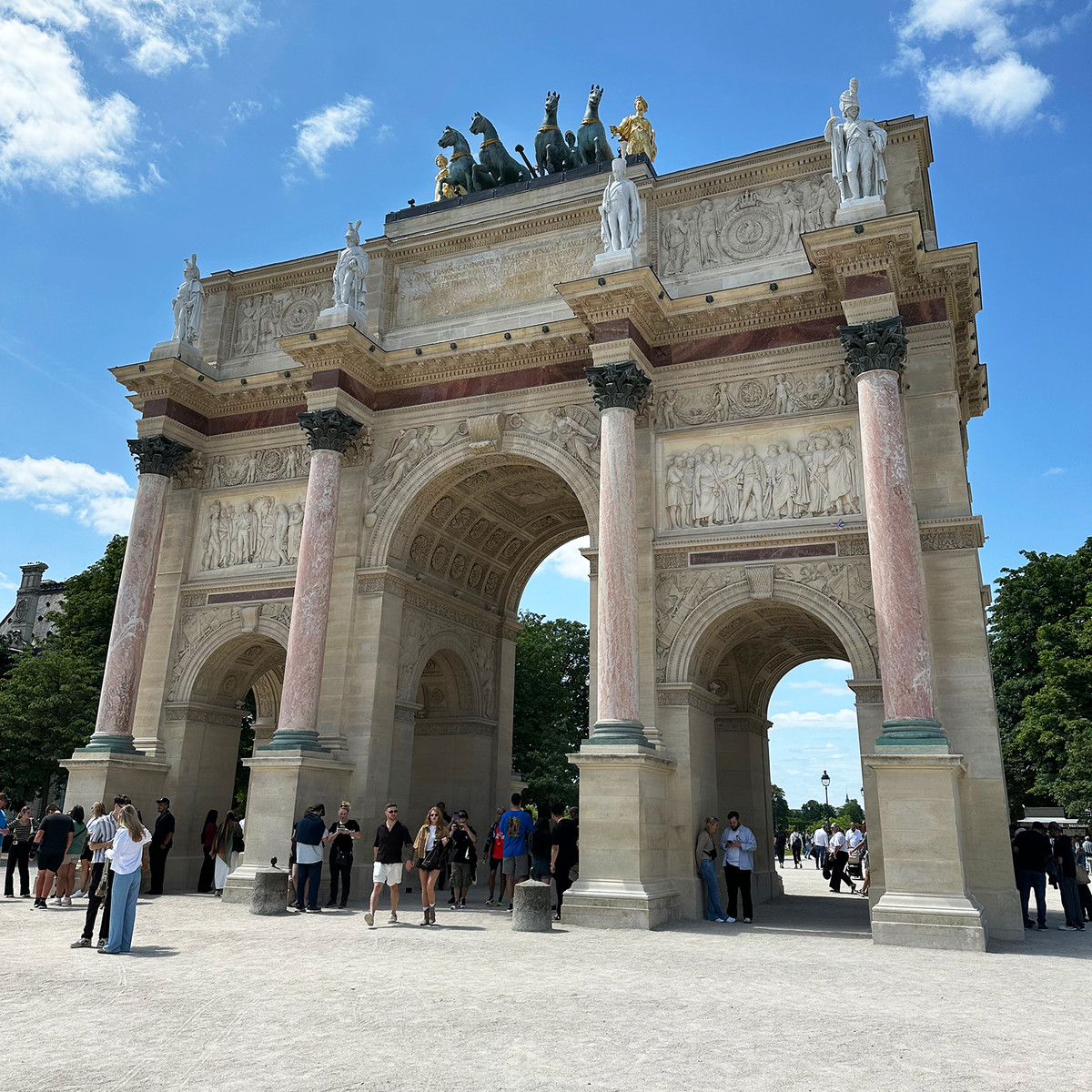 Arc de Triomphe du Carrousel
Standing between the Louvre and the Tuileries Garden, this triumphal arch marks one of Paris's most elegant transitions from palace courtyards to open green spaces.