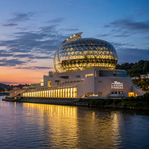 An architectural marvel located on Île Seguin, La Seine Musicale features a striking modern design with sweeping curves and a glass facade that reflects the vibrant energy of the Parisian skyline. The image highlights the expansive concert hall, with high-tech lighting and a large stage, bustling with activity during a live performance. The venue offers an immersive cultural experience, showcasing both the stunning interior and the dynamic atmosphere of concerts, making it a must-visit destination for music lovers in Paris.