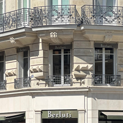 Elegant Haussmann façades frame the Berluti boutique, reflecting the timeless sophistication of Rue de Sèvres.