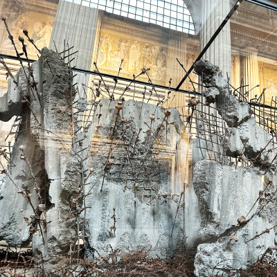 Historic monuments and contemporary installations create a striking contrast within the sacred space.