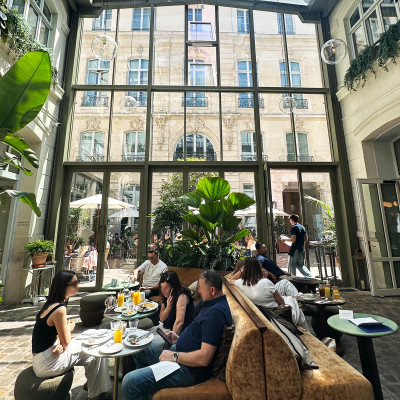 Natural light pours through the soaring glass atrium, creating an inviting lounge where guests gather to work remotely, enjoy coffee or simply relax throughout the day.