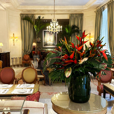 A magnificent floral arrangement welcomes guests into the elegant lobby of Le Bristol Paris, where crystal chandeliers, marble floors, and timeless French décor create one of the city's most iconic luxury hotel interiors. The refined lounge is a peaceful setting for afternoon tea, quiet meetings, or simply soaking up the hotel's unmistakable Parisian atmosphere.