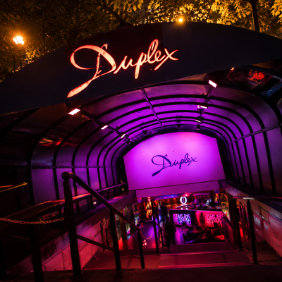 Le Duplex, a vibrant multi-room club near the Arc de Triomphe, brings together diverse music genres including hip-hop, EDM, and pop, creating an energetic party atmosphere. With its exclusive VIP sections, themed nights, and top-tier DJs, it's one of the must-visit spots for Parisian nightlife enthusiasts.