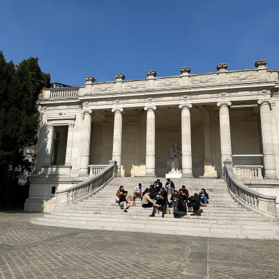 Palais Galliera steps — a pause between exhibitions, where visitors gather and the museum becomes part of the city rhythm.