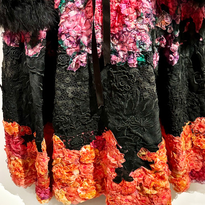 Couture in the Details
A closer look reveals the extraordinary craftsmanship behind haute couture. Embroidery, layered fabrics and hand-finished floral elements demonstrate the level of artistry required to bring a single design to life.