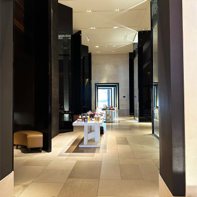 Before reaching the famous courtyard, visitors pass through a series of dramatic interiors defined by soaring ceilings, dark wood panels, and carefully curated displays. The atmosphere immediately sets the tone for the Costes experience.