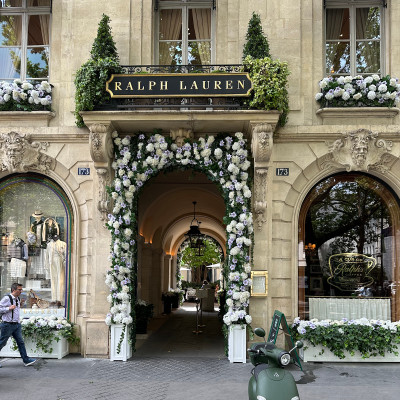 The entrance on Boulevard Saint-Germain — a floral-framed passage into the Ralph Lauren universe.