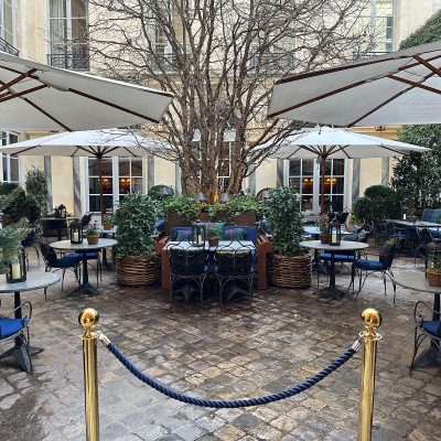 Rain-softened cobblestones at Ralph’s Restaurant — where the courtyard stays warm, intimate, and quietly elegant even in winter.