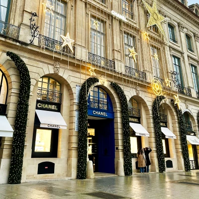 The illuminated façade of Chanel on Vendôme captures the festive elegance and cinematic atmosphere of Paris during the holiday season.