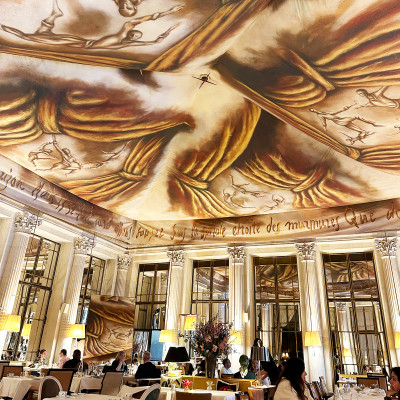 Afternoon tea beneath a dream.
Dalí’s vision unfolding above every table.