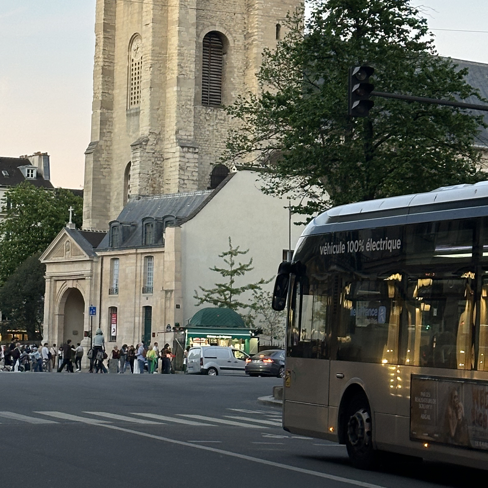Paris public bus passing Opéra Garnier, with Parisian architecture and the famous Opéra district in the background