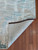 Corner of the Spackle rug is flipped up showing detail on the bottom of the rug. Corner of the Spackle rug is flipped up showing detail on the bottom of the rug.