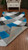 Corner of the rug is flipped up showing detail and texture on the bottom. Corner of the rug is flipped up showing detail and texture on the bottom.