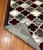 Corner of the rug is flipped up showing texture on the bottom. Corner of the rug is flipped up showing texture on the bottom.