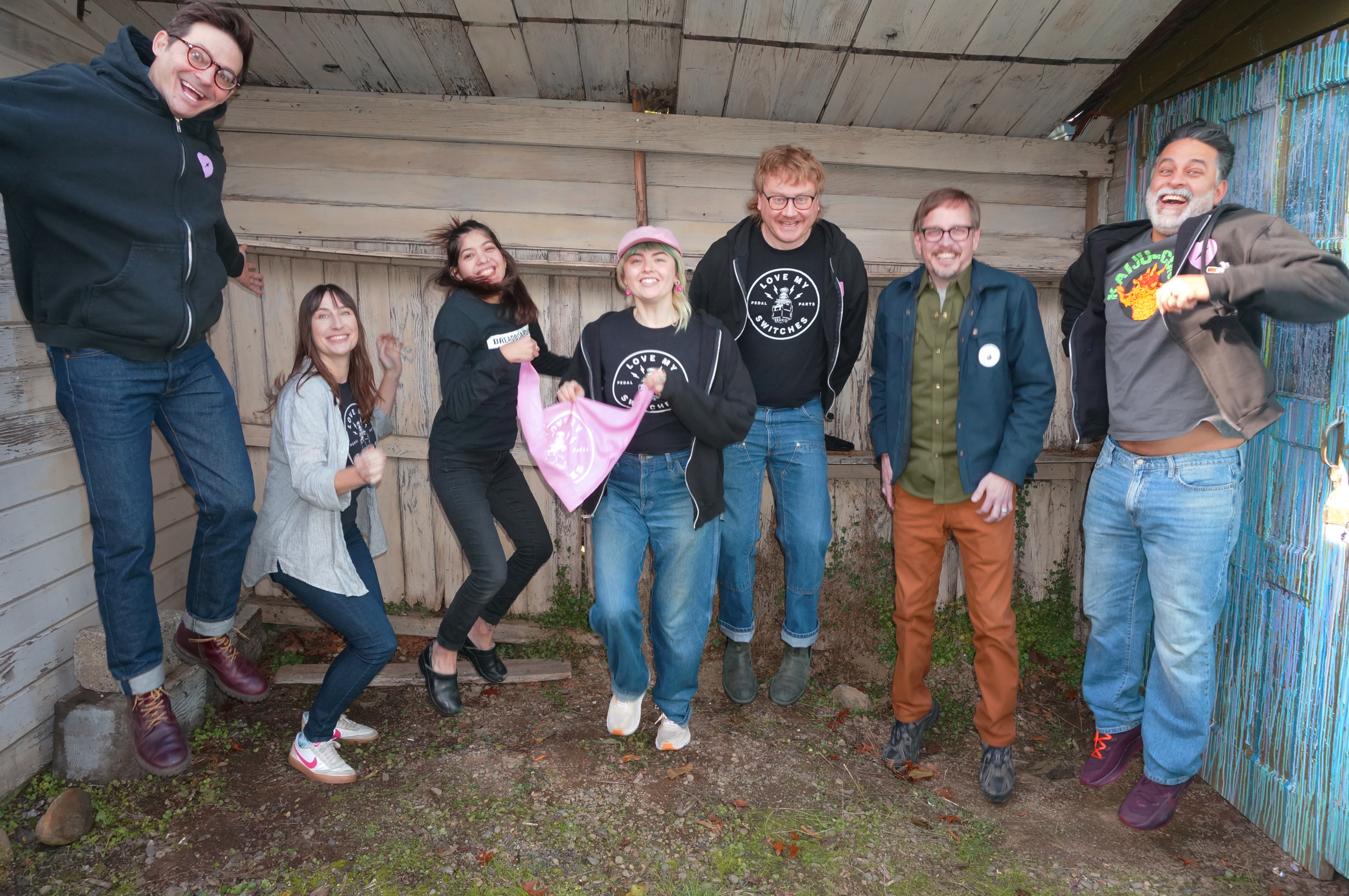 2025 Love My Switches Staff Photo staff jumping in front of wall