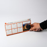 <p>Make your mark with these custom printed desk calendars. A clever and memorable giveaway for your next marketing campaign. These foldable calendars aren’t just practical, they’re a great way to get your logo seen every day. With the option for repositionable tape on the base, they’ll stay put on computer monitors or shop counters, ensuring your message is always front and centre. Customise them as a year calendar, with months, memorable moments, or highlight special days, whatever suits your message best.</p>
<p>&nbsp;</p>
<p>(Also known as variable-information printing (VIP) or VI) is a form of digital printing, including on-demand printing, in which elements such as text, graphics and images may be changed from one printed piece to the next, without stopping or slowing down the printing process and using information from a database or external file.<br />
For example, a set of labels, each with the same basic layout, can be printed with a different name on each label. Variable data printing is mainly used for direct marketing, customer relationship management, advertising, invoicing and applying addressing on selfmailers, brochures or postcard campaigns.<br />
“Not intended for washing/submerging into water, to clean coasters please wipe down with a damp cloth only”.</p>
