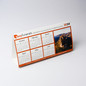 <p>Make your mark with these custom printed desk calendars. A clever and memorable giveaway for your next marketing campaign. These foldable calendars aren&#8217;t just practical, they’re a great way to get your logo seen every day. With the option for repositionable tape on the base, they’ll stay put on computer monitors or shop counters, ensuring your message is always front and centre. Customise them as a year calendar, with months, memorable moments, or highlight special days, whatever suits your message best.</p>
<p>&nbsp;</p>
<p>(Also known as variable-information printing (VIP) or VI) is a form of digital printing, including on-demand printing, in which elements such as text, graphics and images may be changed from one printed piece to the next, without stopping or slowing down the printing process and using information from a database or external file.<br />
For example, a set of labels, each with the same basic layout, can be printed with a different name on each label. Variable data printing is mainly used for direct marketing, customer relationship management, advertising, invoicing and applying addressing on selfmailers, brochures or postcard campaigns.<br />
“Not intended for washing/submerging into water, to clean coasters please wipe down with a damp cloth only”.</p>
